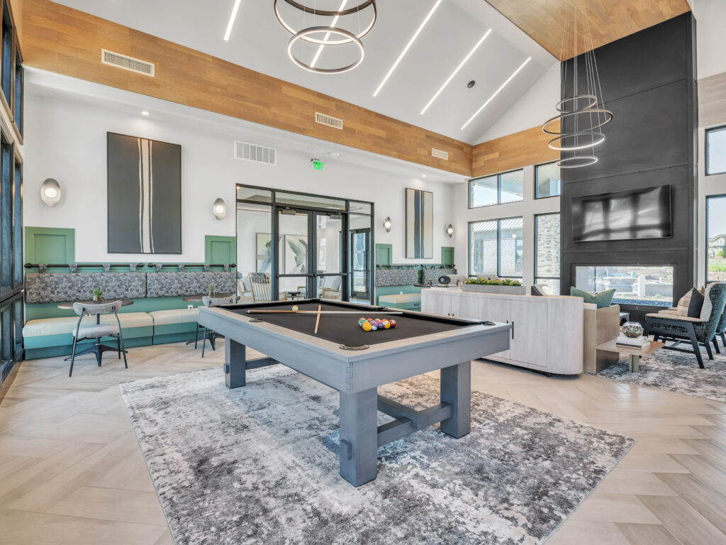Modern communal space with a pool table, comfortable seating, and contemporary decor